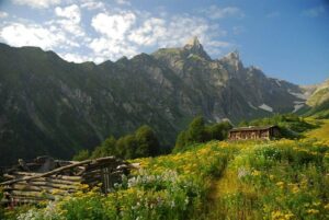 a mountain with a house and a fence